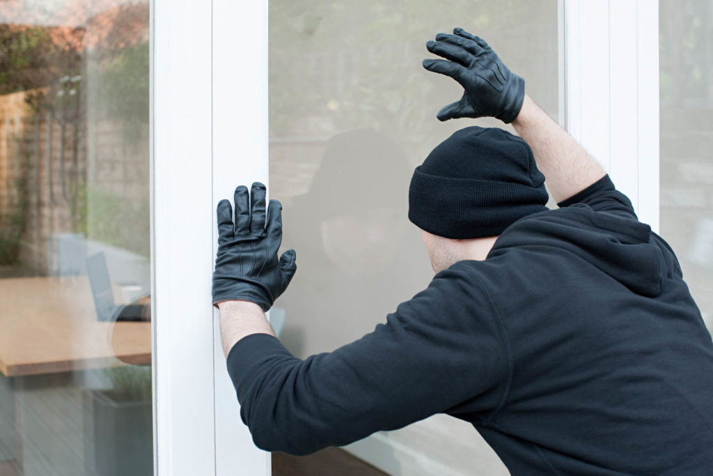 burglar-breaking-into-vacant-rental-home
