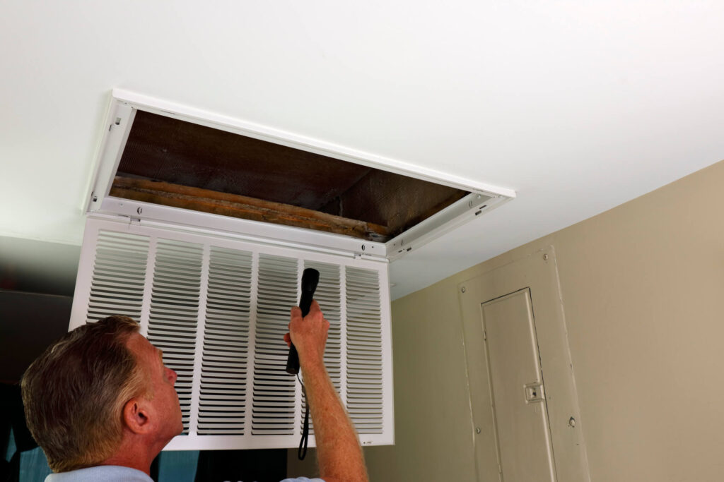 Arizona HVAC technician inspects air conditioning for landlord's rental property