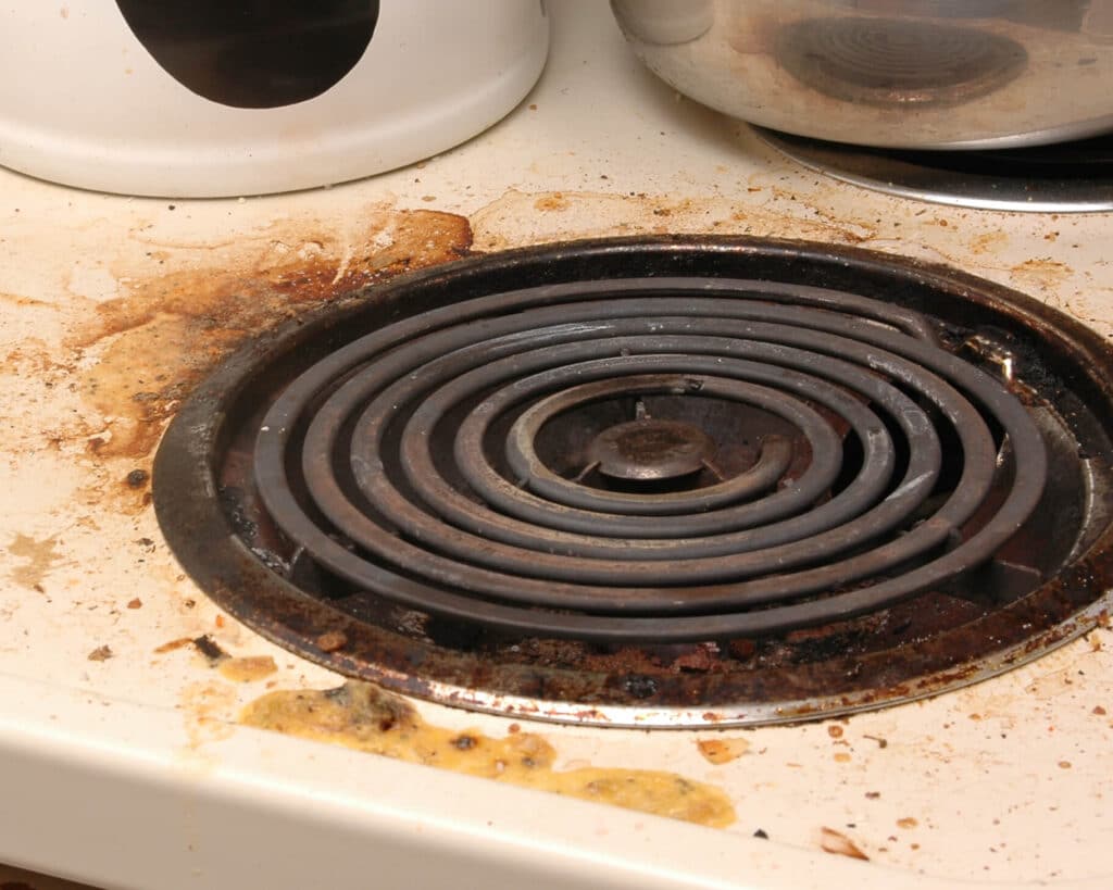Dirty stove top from a bad tenant in a Phoenix rental property. 