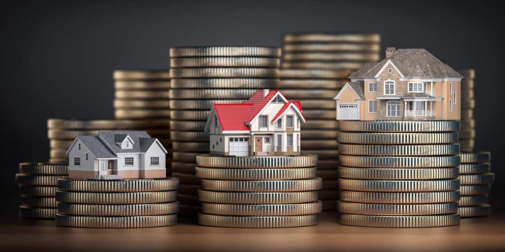Houses stacked on coins represent improving the value of your rental property in Chandler, AZ.