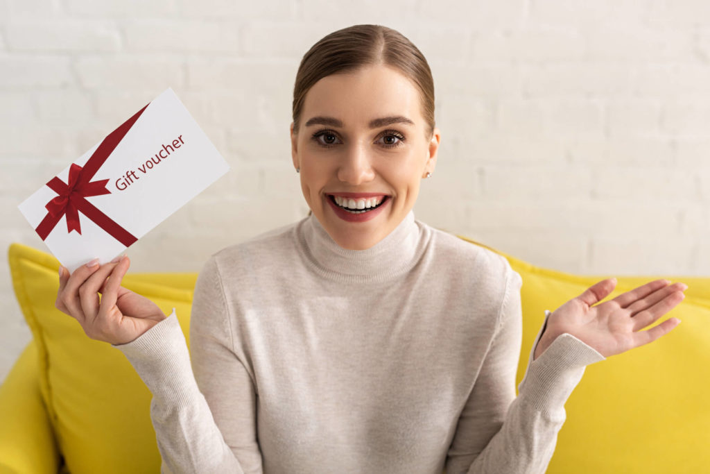 happy renter holding gift card from their  Gilbert property manager