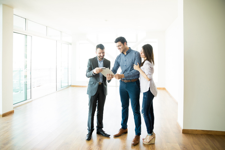 Scottsdale Property Manager Handing a Professional Rental Lease for New Tenants to Sign